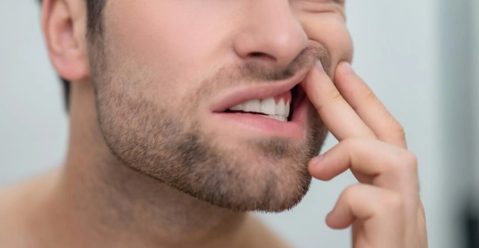 man checking his teeth