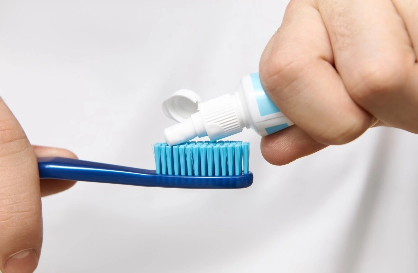 squeezing tooth paste